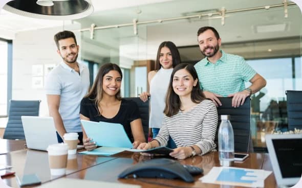 Five members of the EduCuby team gathered around a work table in an open-plan office